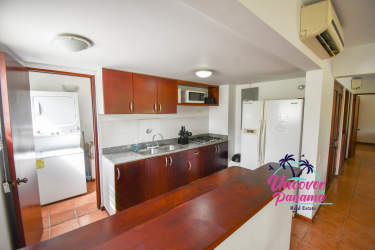 Kitchen featuring wood cabinets and breakfast bar at Costa Blanca Golf Villas Panama