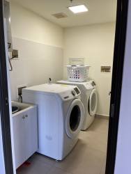 Laundry room with washer dryer hookup, utility sink, storage shelves in PH Madeira Panama