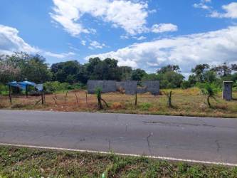 Large corner lot with partial brick fence and metal posts on rural main road near Volcán Panama