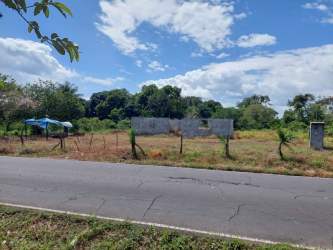 Fence and partly built concrete walls dividing 2000 sqm rural roadside lot in Santo Domingo Panama
