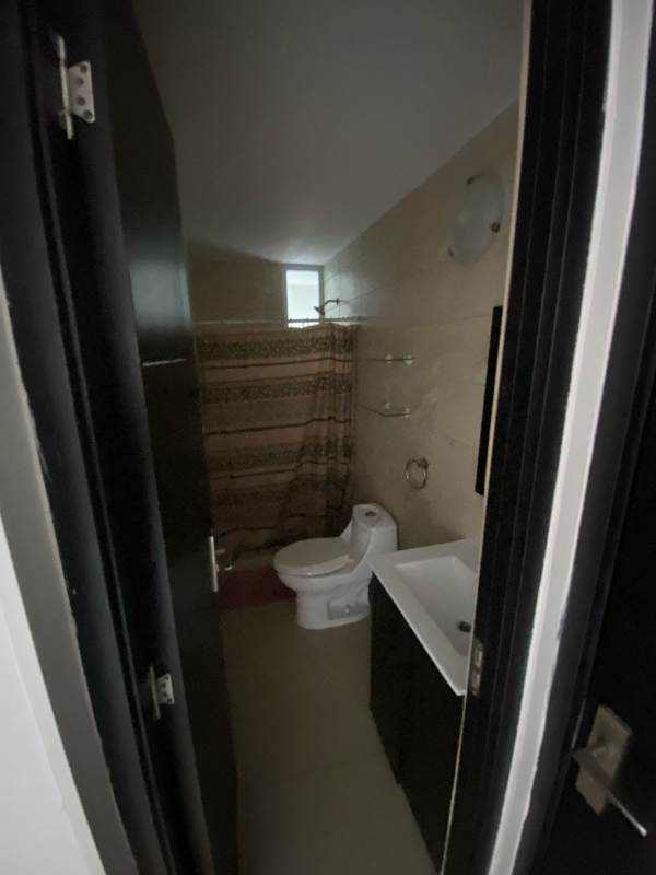 Bathroom with toilet, vanity sink, mirror and shower curtain PH Carrasquilla Park in Panama City