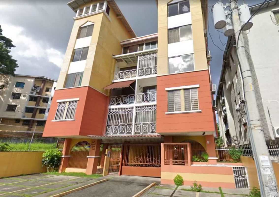 Modern mid-rise apartment tower exterior with balconies and gate at PH Nuevo Hato Pintado Panama