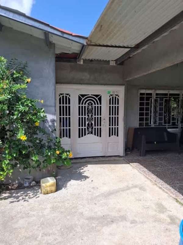 Security doors and porch view of rural home in Panama Chepo Tortí
