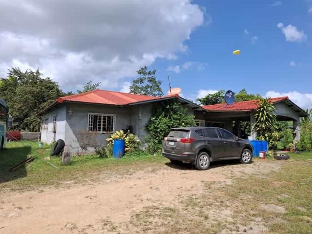 Exterior front view of single family rural house with carport and garden Chepo Tortí Panama