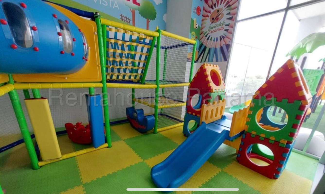 Bright indoor children's playground at PH Altamira with slides and colorful play structures