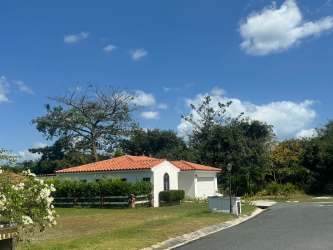 Mediterranean villa with red tile roof and lush landscape inside Hacienda Pacifica Panama Oeste