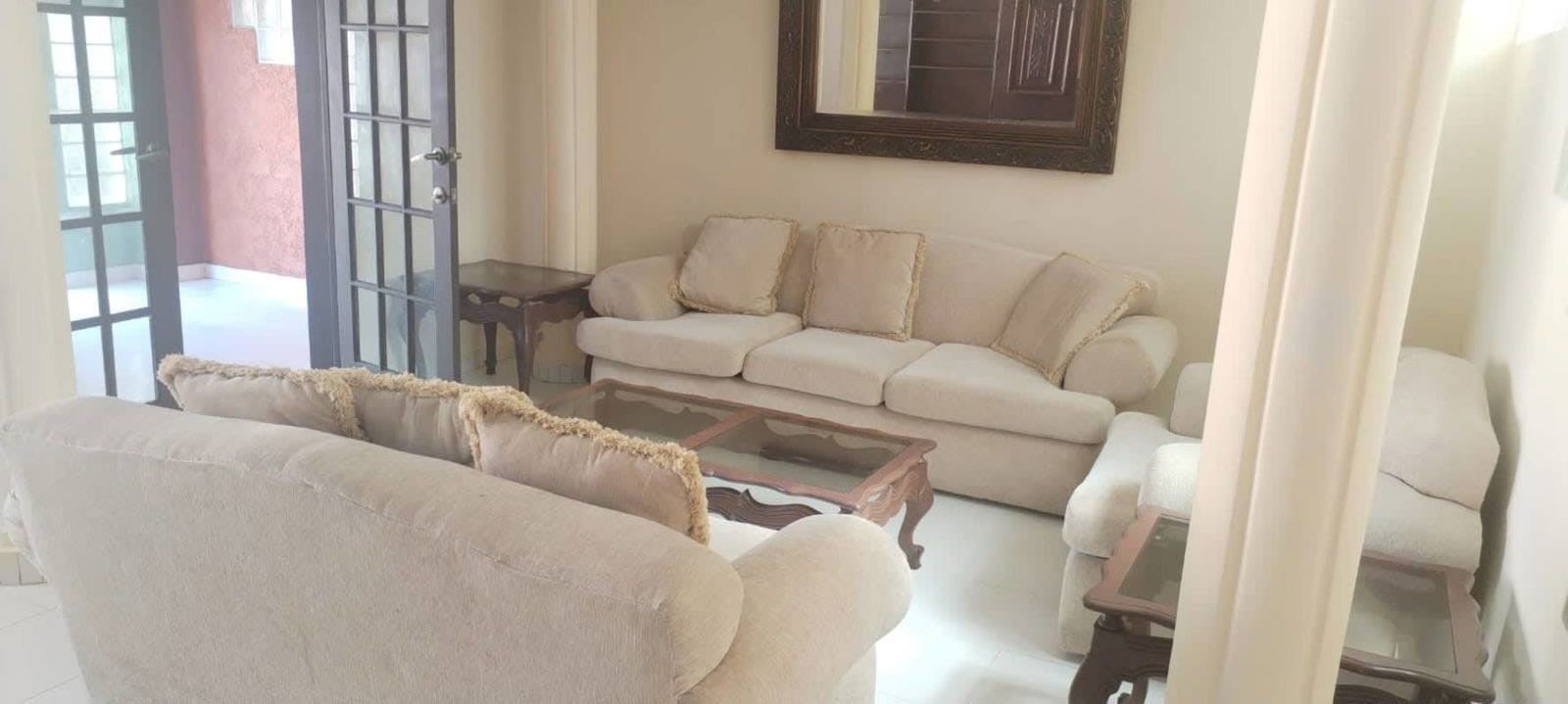 Bright living room with beige sofas, French doors, and natural lighting Fuente del Fresno Condado del Rey Panama