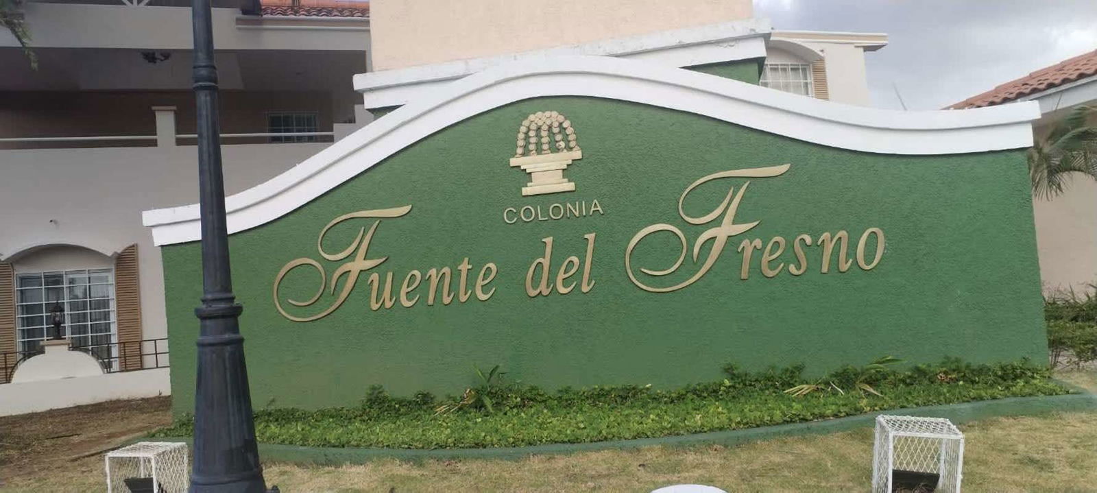 Entrance signage of Fuente del Fresno gated residential community with landscaped garden in Condado del Rey Panama