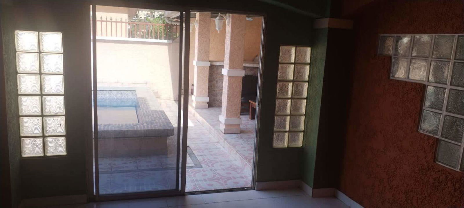 Modern kitchen with stainless appliances granite countertop red cabinets Fuente del Fresno Panama