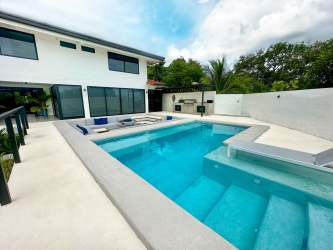 Private swimming pool with sun deck, barbecue patio and tropical landscaping at luxury beach house Costa Esmeralda Panama