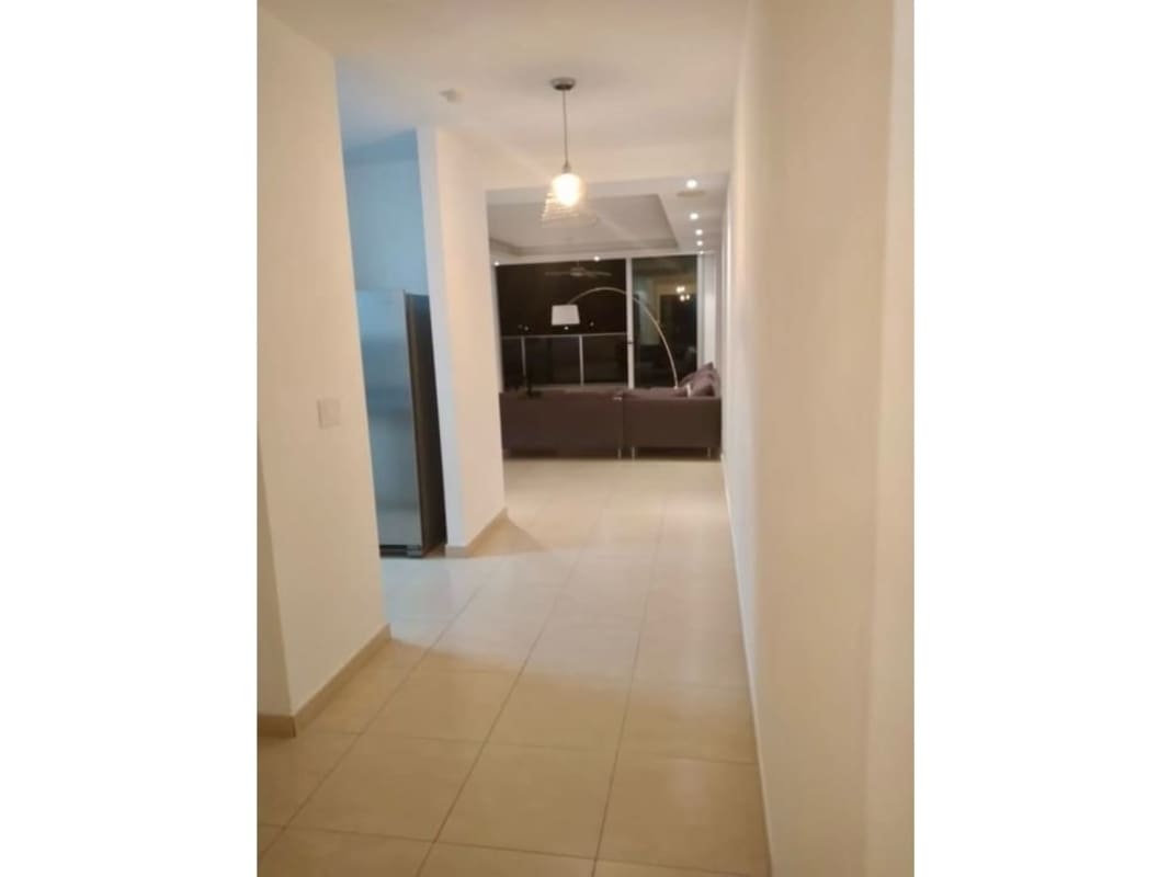 Modern living room with large windows and city skyline views Avenida Balboa