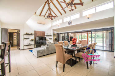 Covered patio with garden view, pool, and outdoor dining at golf villa Costa Blanca Panama