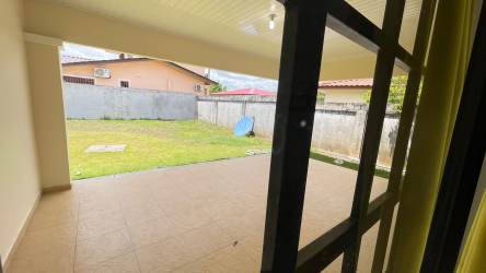 Large covered terrace and fenced green backyard in corner lot house David Chiriquí