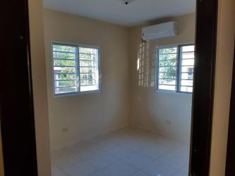 Bedroom with air conditioning unit, two windows, ceramic floors in David house for sale