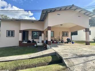 Bright living dining room with tiled floors and windows in San Carlitos David house for sale