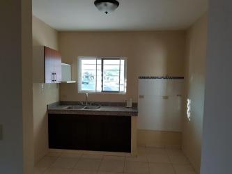 Minimalist kitchen with window, cabinetry, tiled walls and double sink in David house for sale