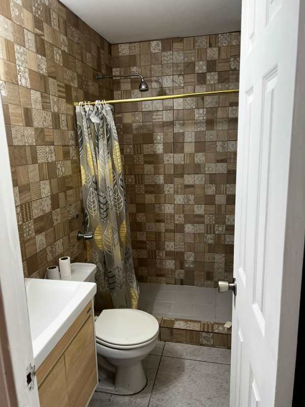 Modern bathroom with walk-in shower, mosaic tiles, and vanity at PH Mystic Hills