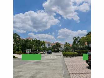 Gated luxury residence with manicured lawn, palm trees, and pool overlooking Santa María golf course in Panama City