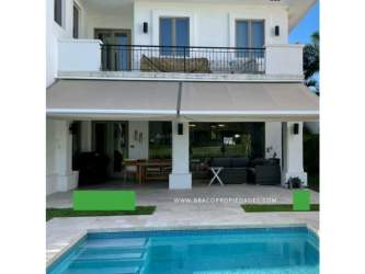 Luxury modern two-story house with large balcony, outdoor pool and lounge area in Santa María Golf Panama City