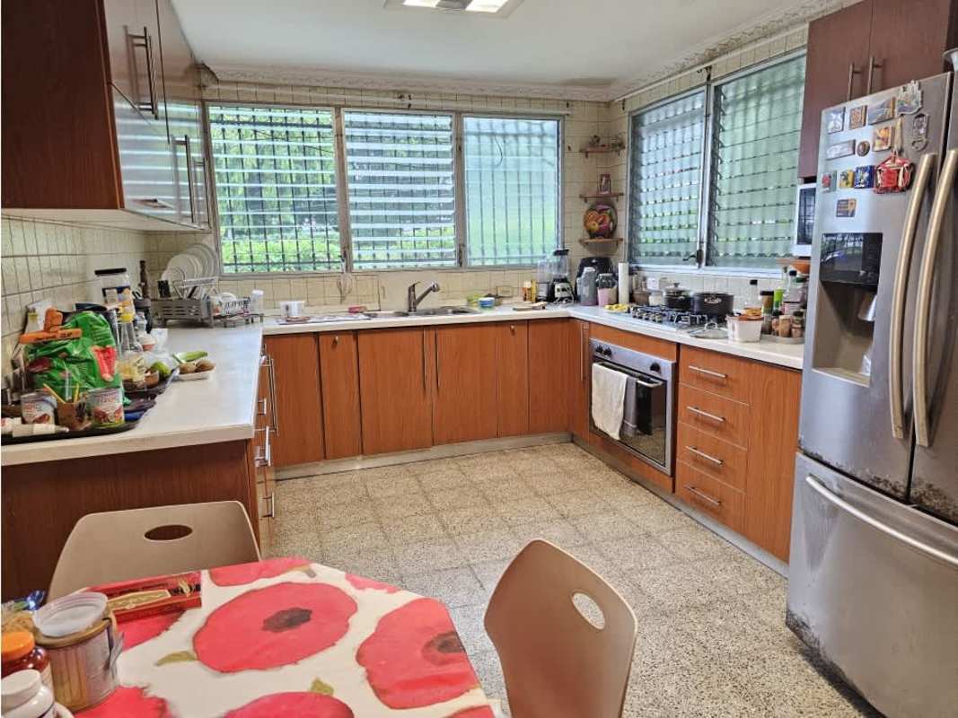 Bright kitchen with wooden cabinets and appliances in commercial house for sale Panama City