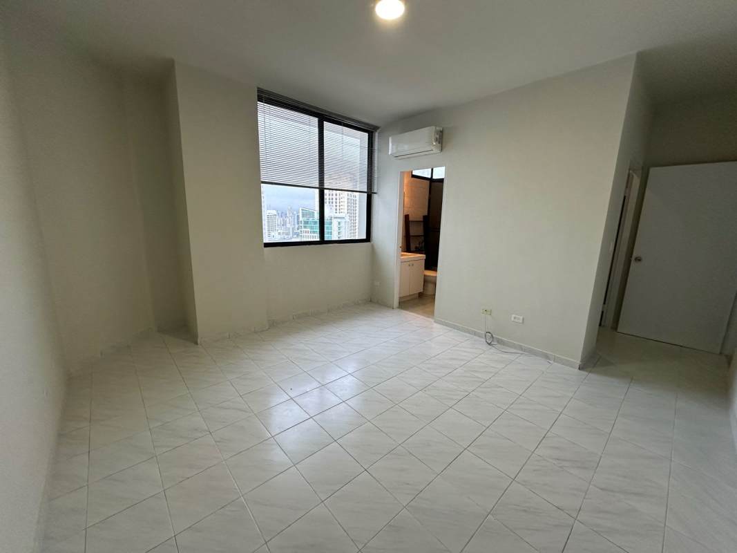 Living room with large window city view, split AC, tiled floors at PH Vista Tower Bella Vista.