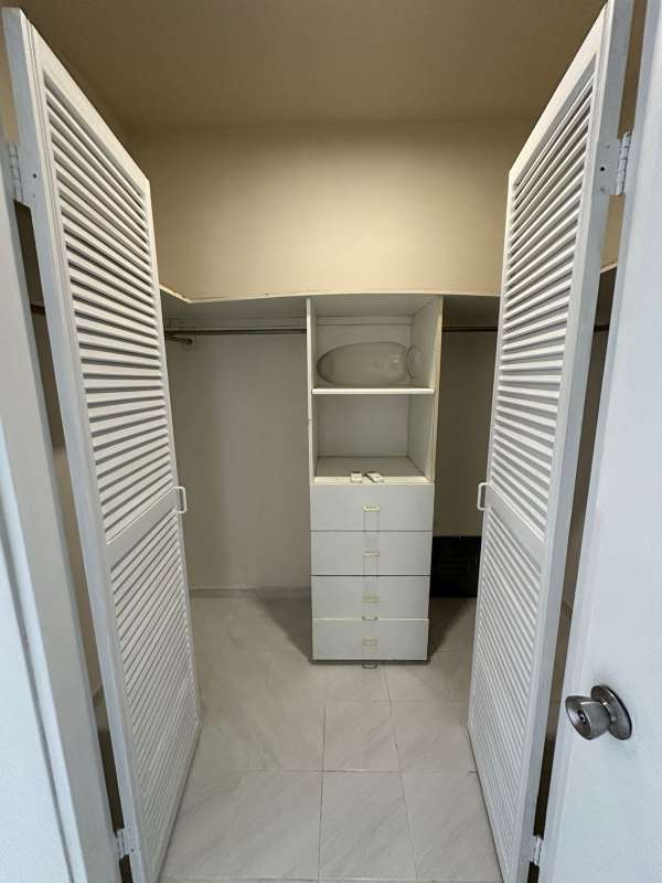 Empty living room with marble tiled floors, panoramic city view window Vista Tower Panama.