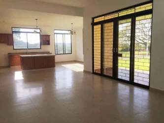 Contemporary kitchen with center island granite wood cabinetry tile floor in David Panama