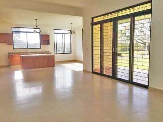 Spacious open-concept living room with kitchen island granite countertops large windows David Panama