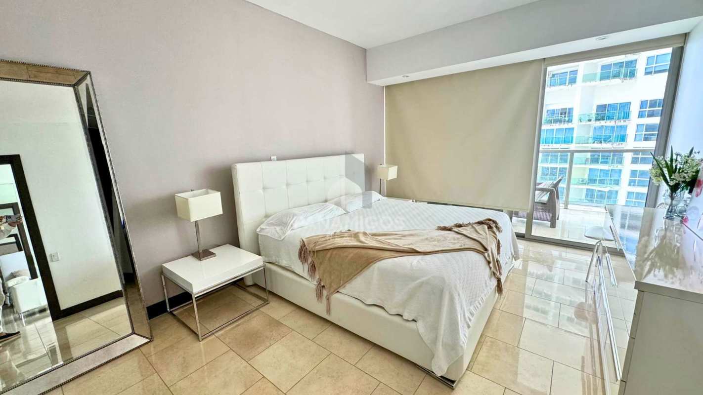 Modern bedroom with access to balcony and ocean skyline views in The Ocean Club Panama Punta Pacifica