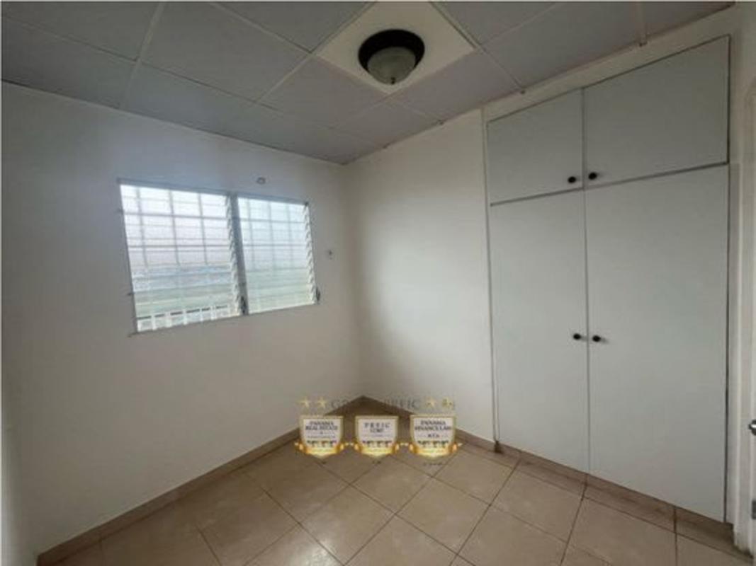 Bedroom with wardrobe, large window and tile flooring in Cerro Viento house Panama