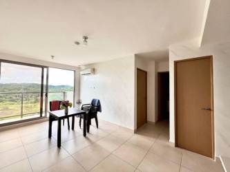 Minimalist dining room with black table and chairs by balcony in PH Parterre Panama Pacifico