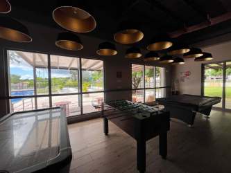 Indoor game room with foosball, pool, air hockey tables large windows PH Parterre Panama Pacifico