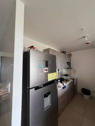 Minimalist kitchen with white counters, gas cooktop and open shelves PH Parterre Panama Pacifico