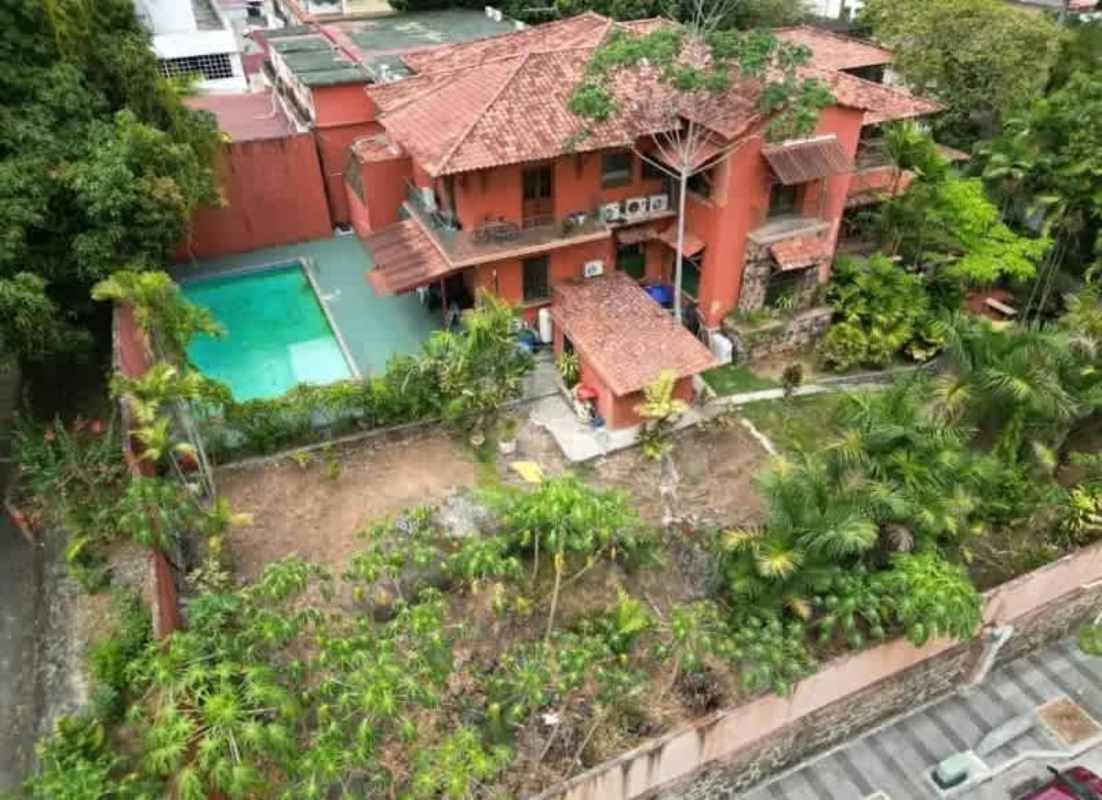 Private residential swimming pool surrounded by tropical garden at Bella Vista mansion Panama