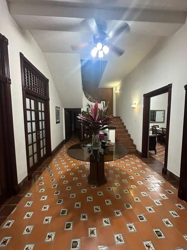 Large open living and lounge space with tile floors inside mansion Bella Vista Panama City