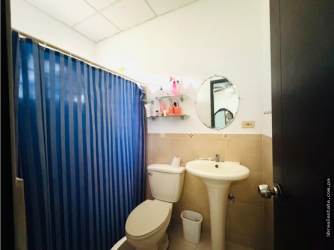 Open concept living and dining area with tiled floors and bright windows house La Fontana David Panama