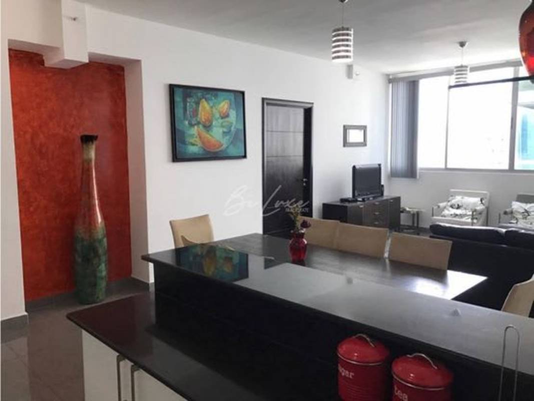 Spacious furnished living and dining room with large windows at PH Quartier 74 Panama City