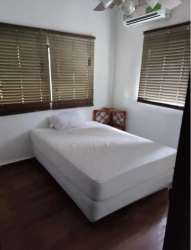 Minimalist bedroom with blinds, pallet bed, neutral colors Coronado Panama beach house
