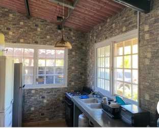 Rustic kitchen with brick walls, double sink, large window Panama beach villa