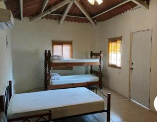Bedroom with wood ceiling beam, AC, bunks and rustic decor in Panama vacation rental