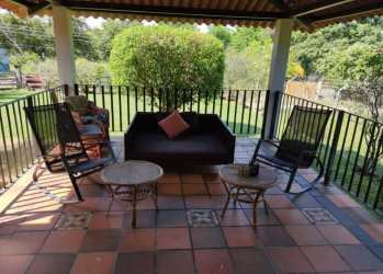 Outdoor patio with rocking chairs, sofa and garden views at vacation villa Panama