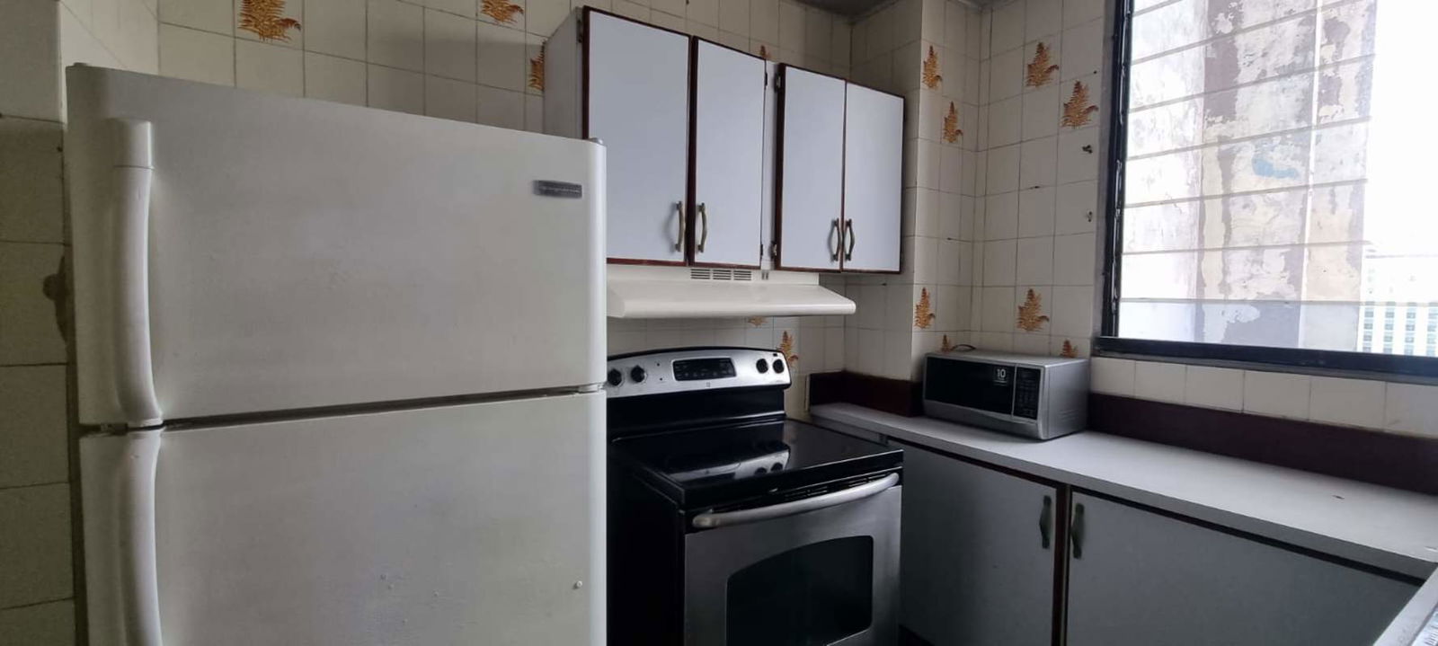 Living and dining space with large window, tile floors in PH Villa Cangrejo El Cangrejo Panama