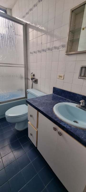 Bedroom with wooden closet, striped bedding, ceiling fan PH Coral Plaza Panama City