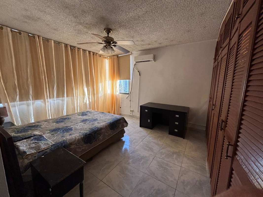 Blue tile bathroom with bathtub, vanity mirror, decorative touches PH Coral Plaza Panama rental