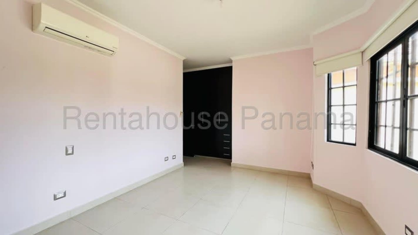 Modern luxury bathroom with marble tiles, step-up bathtub, and double vanity in Costa Sur