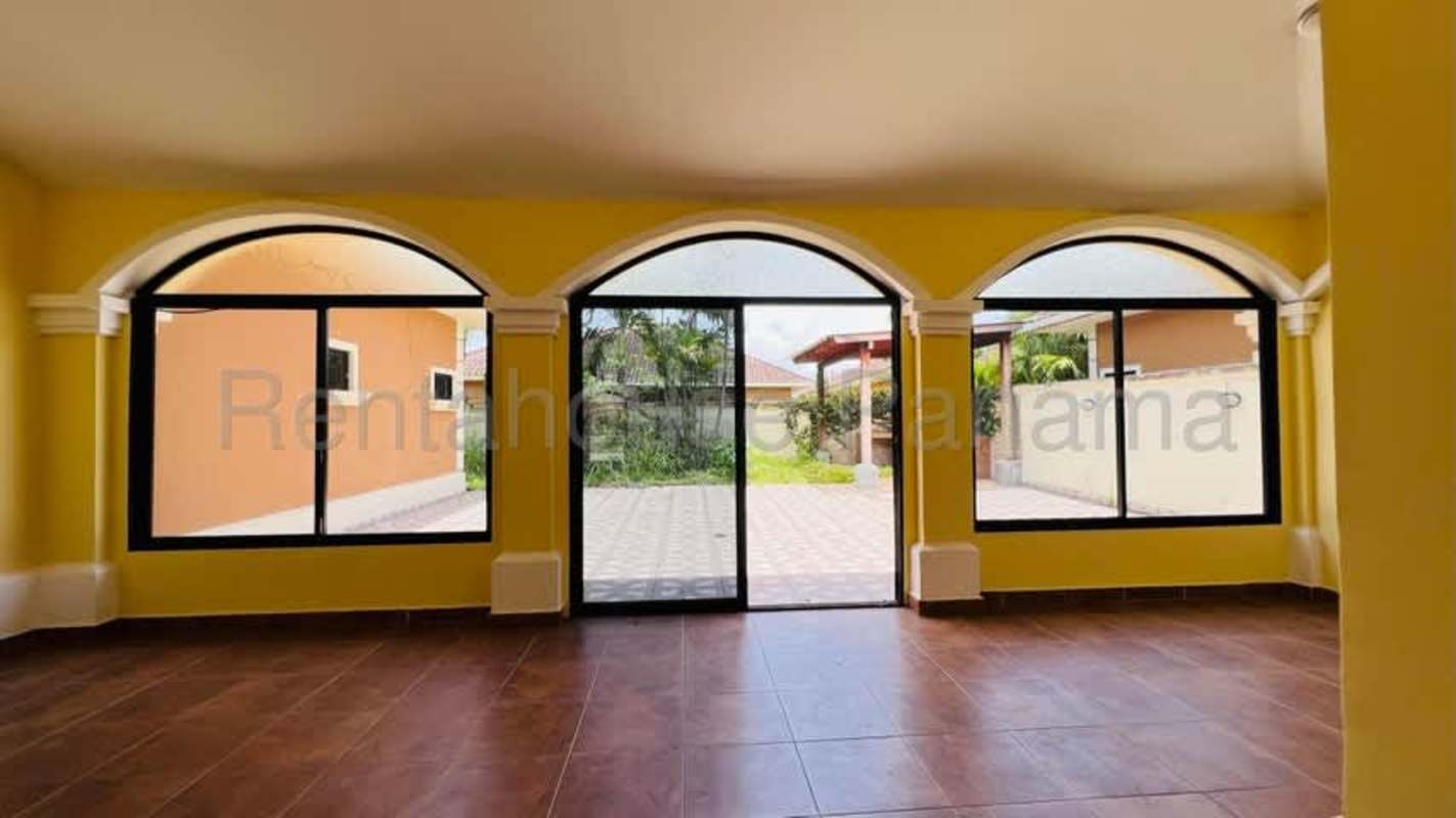 Bright living room with arched windows and ceramic tile floors Costa Sur Panama
