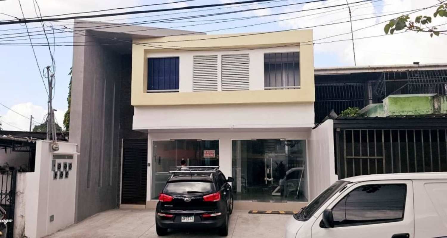 Modern two-story commercial facade with glass windows, parking spaces in Chanis on Via Cincuentenario Panama City