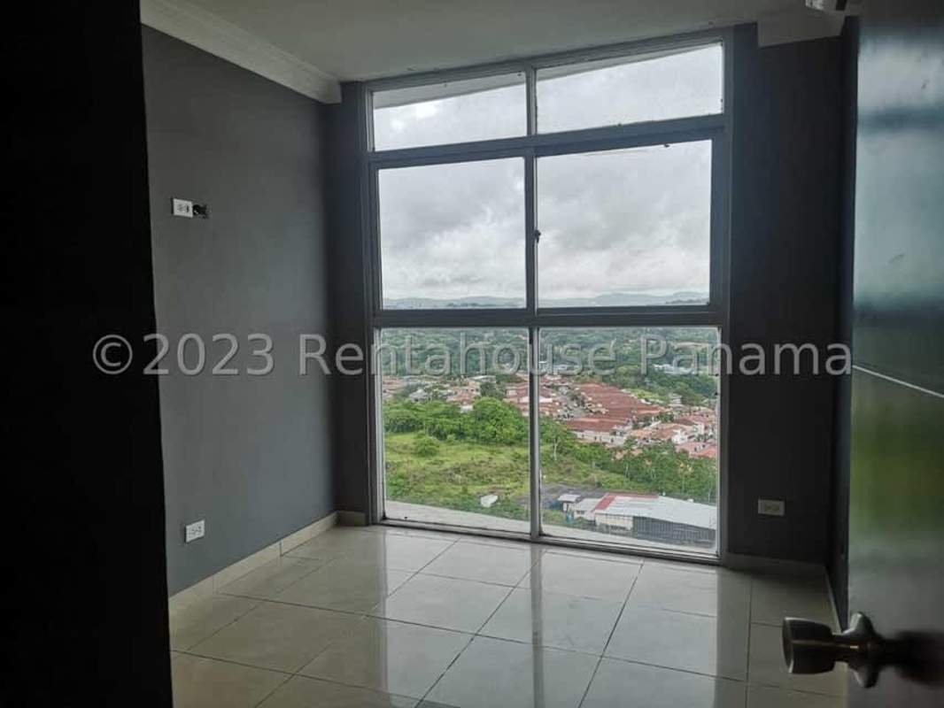 Bedroom with large window and city green view PH Villa de Las Fuentes Panama