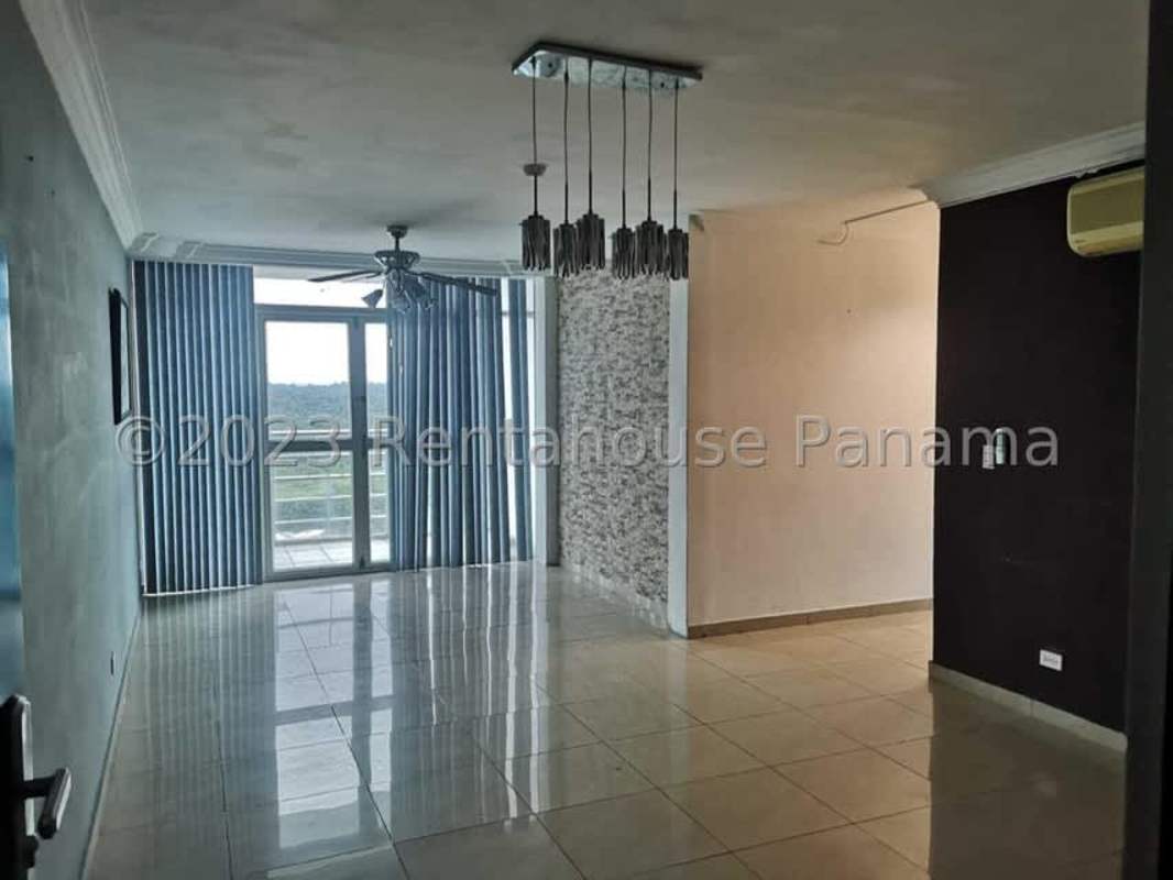 Open living area with panoramic windows and tiled floors in Villa de Las Fuentes Panama