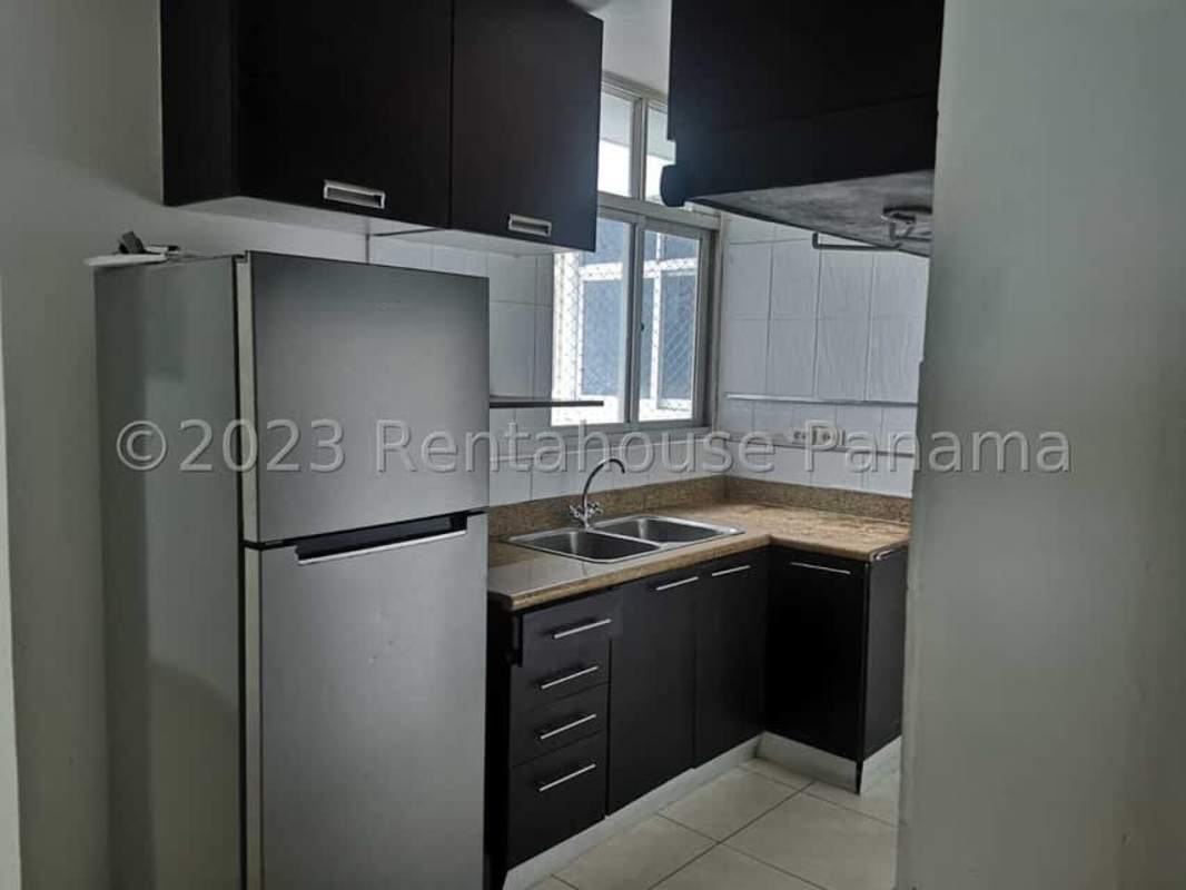 Compact kitchen granite counters black cabinets window PH Villa de Las Fuentes Panama